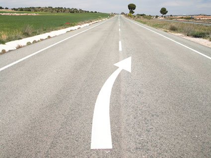 ¿Qué indica la flecha situada en el eje central de la calzada de la imagen?