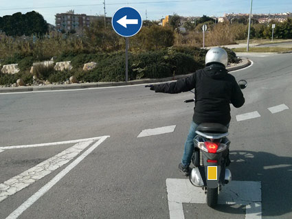 Atendiendo a la señalización del cruce de la fotografía, ¿podrá tomar el conductor la dirección indicada con el brazo?